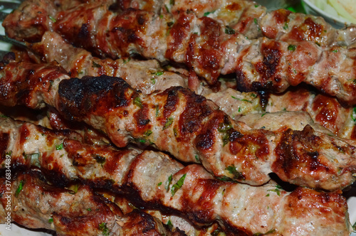 close-up - appetizing tasty shish kebab - marinated pieces of meat fried on skewers