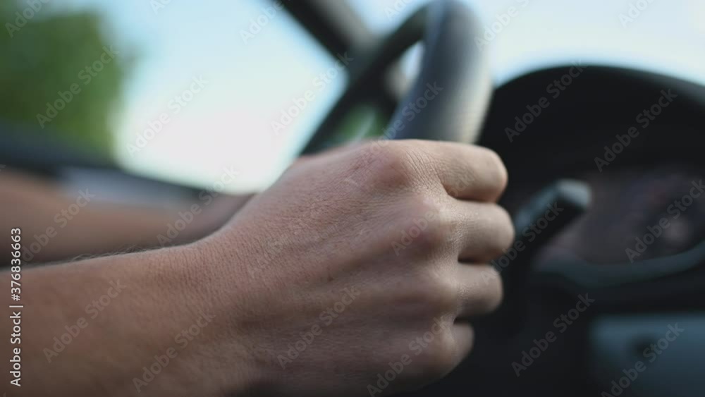 Close Up Of Man Behind Steering Wheel Driving Automatic Car With Manual Mode. Driver Changing Gears By Pressing Manual Shifting Paddles. Close Up Of Man Behind Steering Wheel Driving Automatic Car With Manual Mode. Driver Changing Gears By Pressing Manual Shifting Paddles.