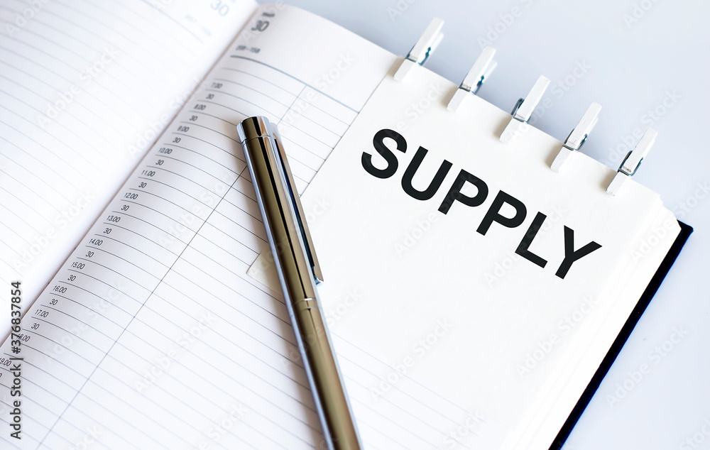 text SUPPLY on the short note texture background with pen text SUPPLY on the short note texture background with pen