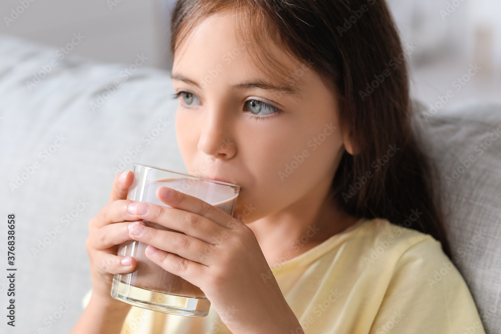 Little girl drinking tasty chocolate milk at home Little girl drinking tasty chocolate milk at home