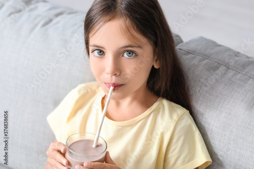 Little girl drinking tasty ...