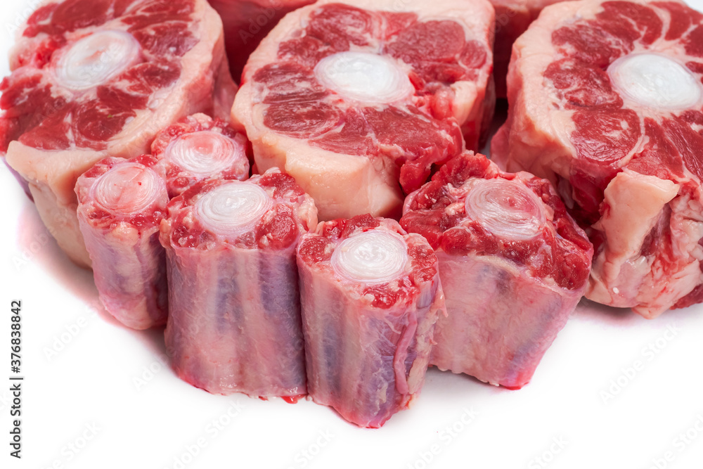 Fototapeta premium Ox tail portions on a white background, Close up. Meat industry concept.