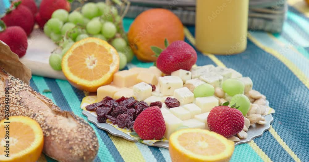 4K slow motion woman hand taking food. Female picking juicy strawberry from french cheese plate. Freshly baked bread with organic juicy ripe fruits. Healthy and balanced diet with orange juice, grapes 4K slow motion woman hand taking food. Female picking juicy strawberry from french cheese plate. Freshly baked bread with organic juicy ripe fruits. Healthy and balanced diet with orange juice, grapes