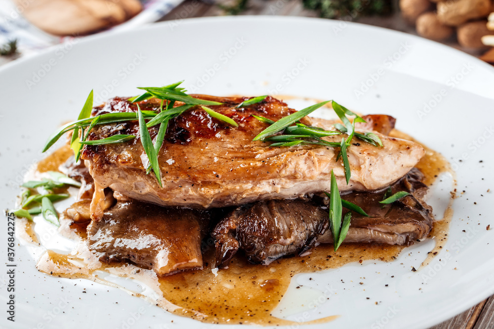 Cooked chicken fillet on mushrooms Cooked chicken fillet on mushrooms