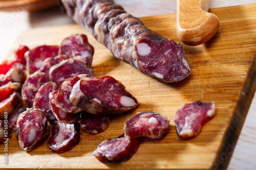Traditional French dried sausage on cutting board. High quality photo