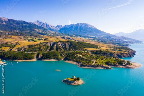 Serene summer landscape of Lake Serre-Poncon, artificial lake surrounded by French Alps, Provence-Alpes-Cote d Azur region photo