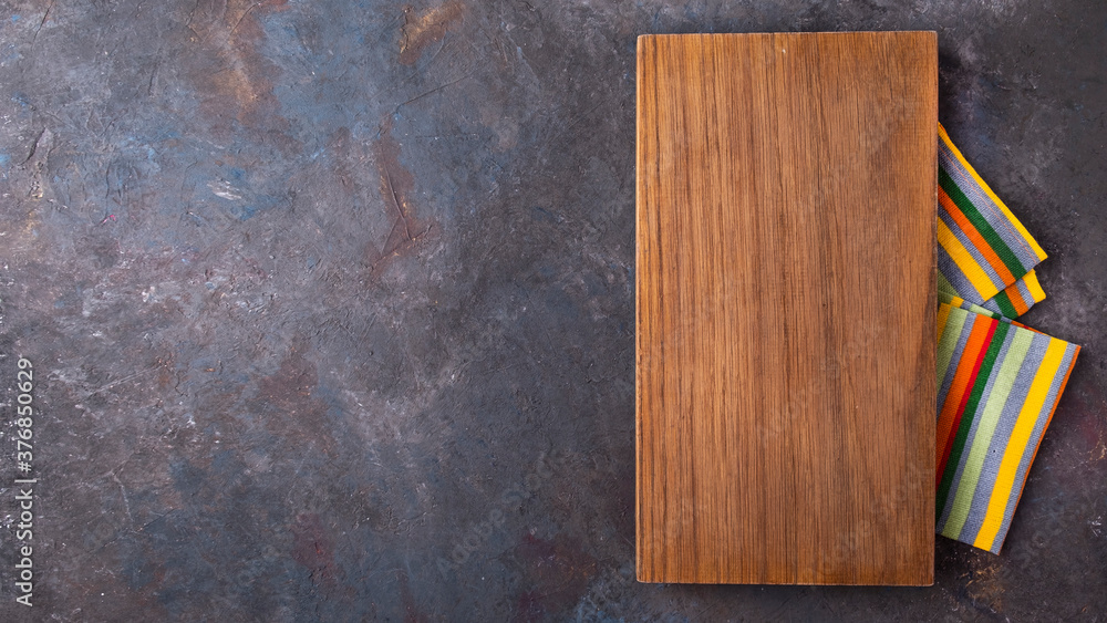 Empry wooden board with napkin. Top view. Copy space