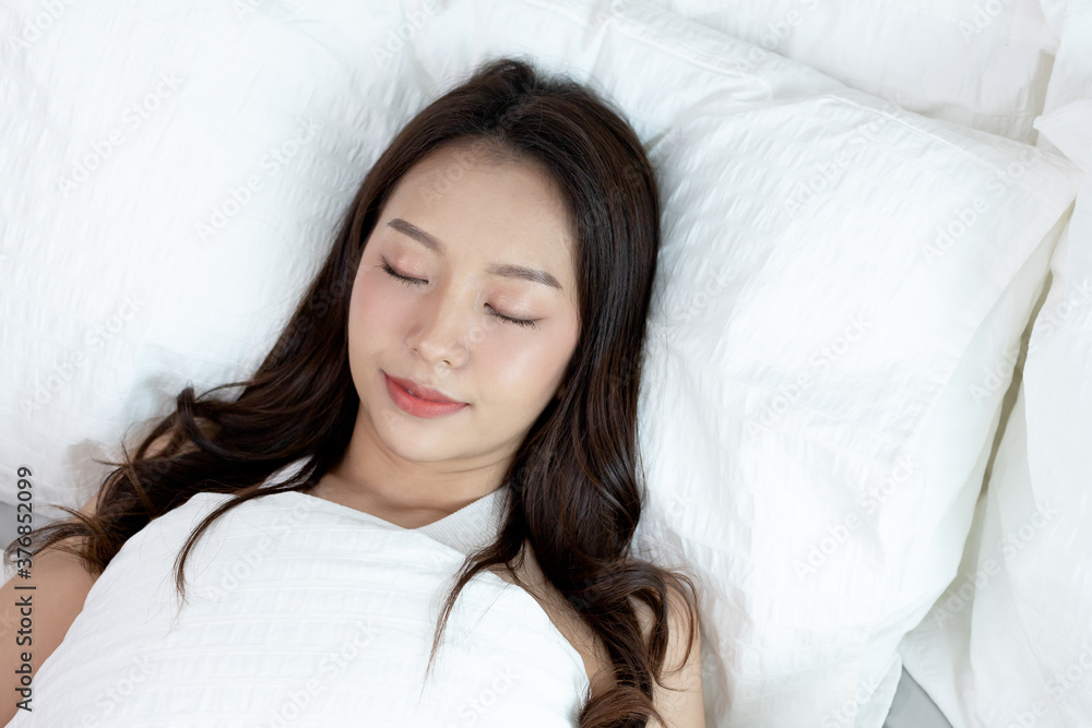 Asian women sleeping and sweet dream on white bed in bedroom Asian women sleeping and sweet dream on white bed in bedroom