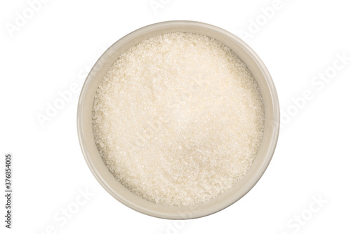 Top view of refined granulated sugar in a white ceramic bowl on white background with clipping path.