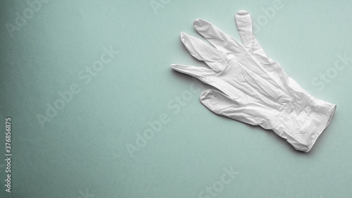 White medical glove on green electric background © lukjonis