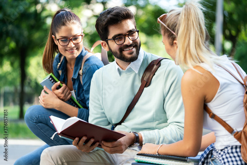 Education, campus, friendship and people concept. Group of happy students outdoor