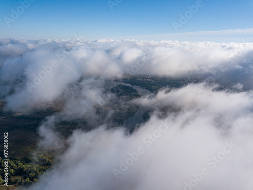 Flight among thick clouds over the Dnieper river in Kiev. © Sergey