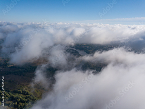 Flight among thick clouds over the Dnieper river in Kiev.