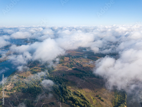 Flying over autumn clouds in Kiev. Sunny morning. © Sergey