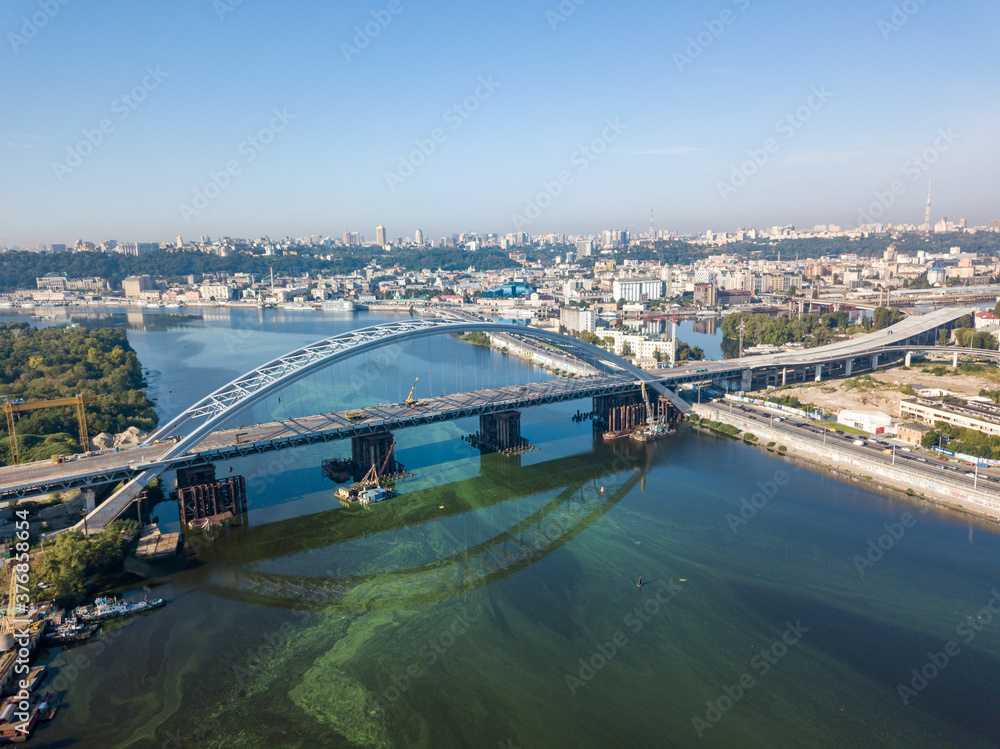 Fototapeta premium Aerial drone view. A cable-stayed bridge under construction across the Dnieper River in Kiev.