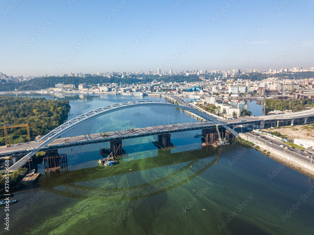 Fototapeta premium Aerial drone view. A cable-stayed bridge under construction across the Dnieper River in Kiev.