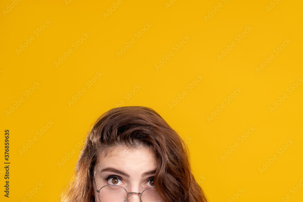 Special offer. Commercial background. Shocked woman eyes in glasses looking at camera isolated on orange copy space. Sale discount. Opportunity chance. Unexpected surprise. Special offer. Commercial background. Shocked woman eyes in glasses looking at camera isolated on orange copy space. Sale discount. Opportunity chance. Unexpected surprise.