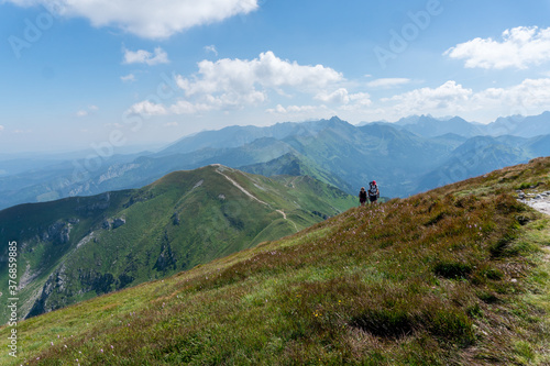 Panoramic view of the Polish Tatra peaks of the mountains during summer morning.
