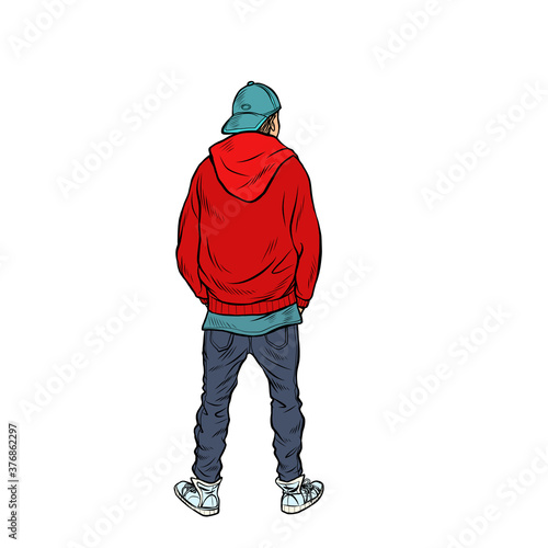 A teenage boy stands back
