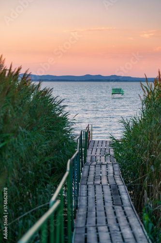 Lake Balaton at sunrise sunset near fonyód with mountain in the background. Tourism in Hungary vacation at the lake in the summer, fishing swimming