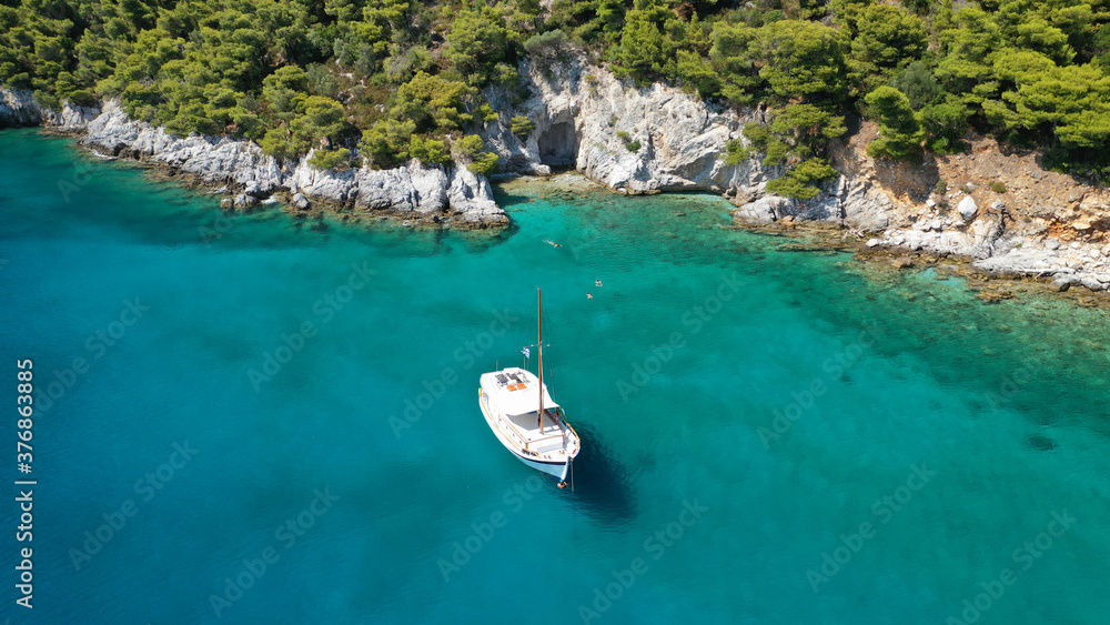 Obraz premium Aerial drone photo of beautiful cave with crystal clear turquoise sea in island of Skopelos visited by boat, Sporades, Greece