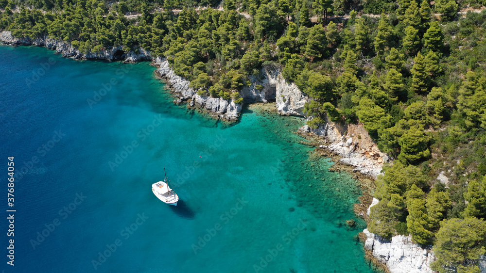 Aerial drone photo of beautiful cave with crystal clear turquoise sea in island of Skopelos visited by boat, Sporades, Greece