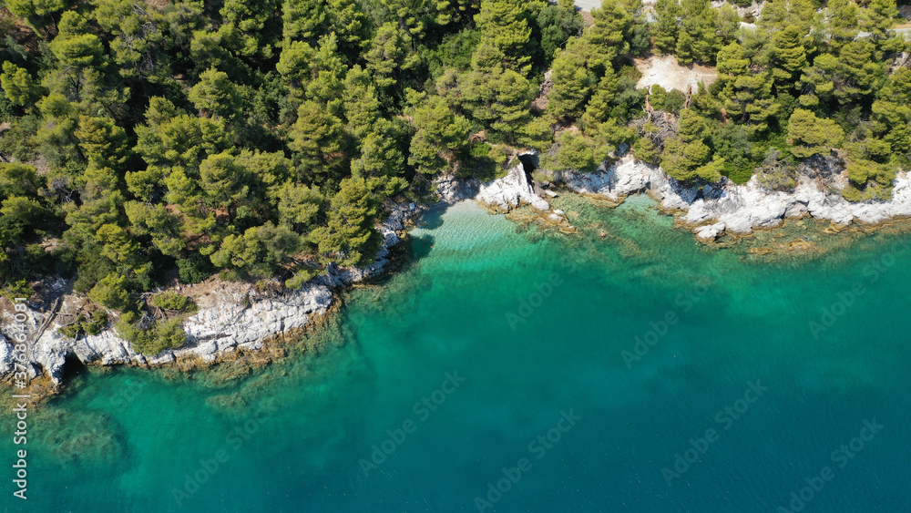 Aerial drone photo of beautiful cave with crystal clear turquoise sea in island of Skopelos visited by boat, Sporades, Greece Aerial drone photo of beautiful cave with crystal clear turquoise sea in island of Skopelos visited by boat, Sporades, Greece