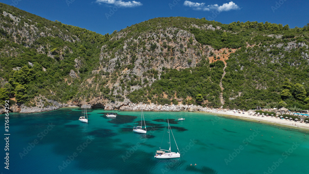 Obraz premium Aerial drone photo of popular crystal clear turquoise beach of Limnonari a safe sail boat anchorage, Skopelos island, Sporades, Greece