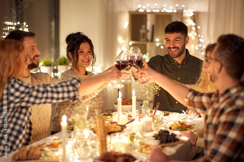 Sticker holidays, celebration and people concept - happy friends having christmas dinner