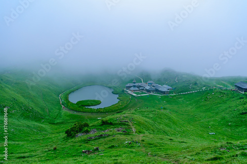 View at Prashar Lake located at a height of 2730 m above sea level with a three storied pagoda-like temple of sage Prashar near Mandi, Himachal Pradesh, India. The lake has a floating island in it