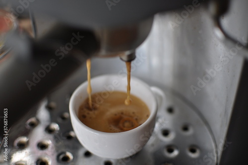 Fresh espresso from coffee machine close up