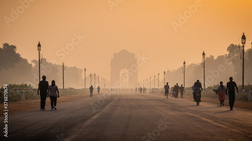 Silhouette of triumphal arch architectural style war memorial during hazy morning. Pollution level rises and causes smog in autumn season due stagnant winds. photo