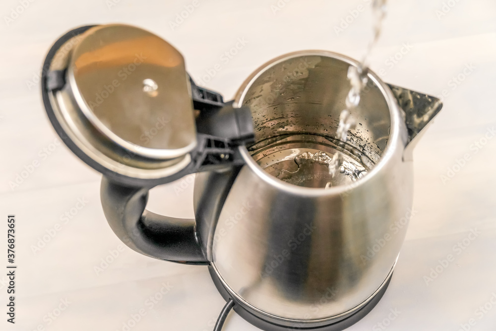 Electric kettle that is filled with water jet, top view Electric kettle that is filled with water jet, top view