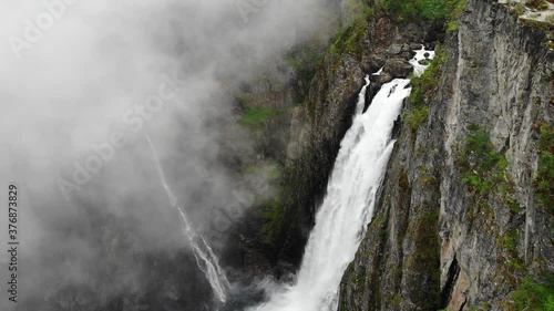 Voringsfossen waterfall, green summer mountains, Mabodalen canyon Norway. National tourist Hardangervidda route, touristroad Rv7, Eidfjord sightseeing tour. photo