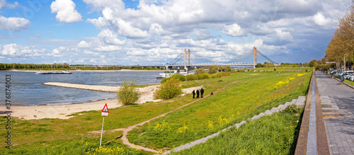 Panoramic view on the riverfront of Zaltbommel, Gelderland, with in the background the famous Martinus Nijhoff suspension bridge crossing the river Waal.
