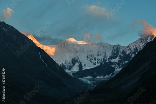 Glacier on Mount Belukha in the rays of the setting sun. Mountain Altai.