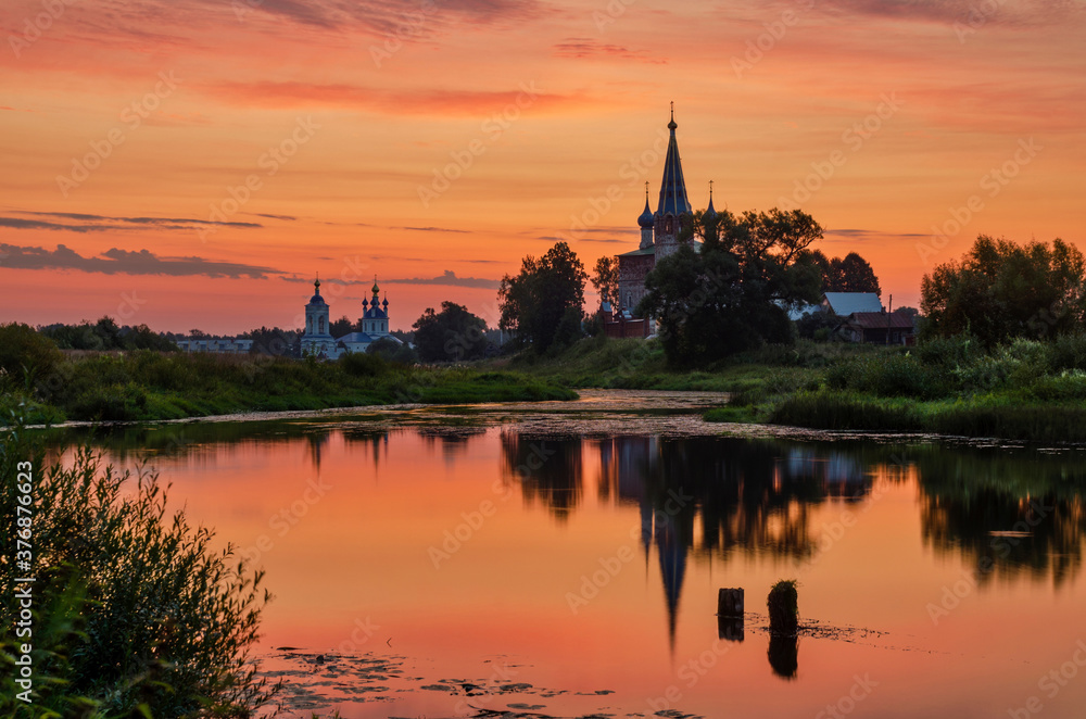 Orthodox convent with beautiful sunset and reflections