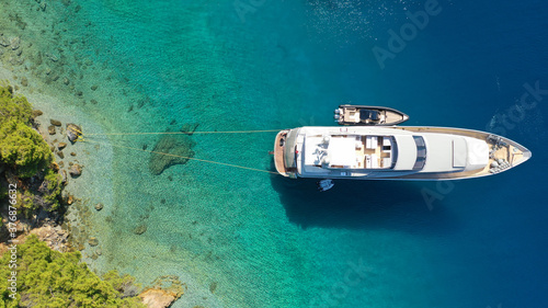 Aerial drone photo of luxury yacht anchored in tropical exotic island bay with turquoise sea © aerial-drone
