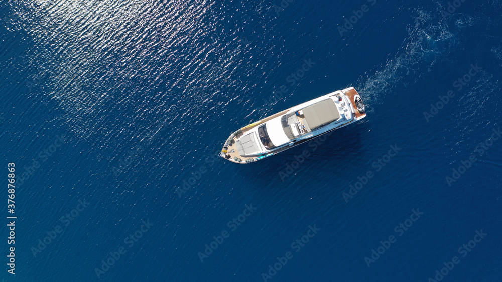 Aerial drone photo of luxury yacht anchored in tropical exotic island bay with turquoise sea