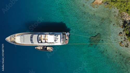 Aerial drone photo of luxury yacht anchored in tropical exotic island bay with turquoise sea