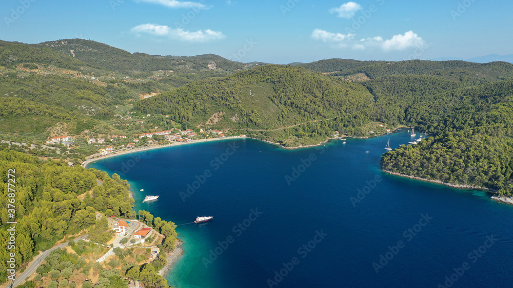 Aerial drone photo of famous crystal clear turquoise beach and bay of Panormos a popular safe sail boat anchorage in island of Skopelos, Sporades, Greece
