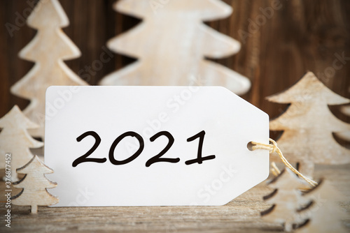 Label With Text 2021. White Wooden Christmas Tree As Decoration. Brown Wooden Background