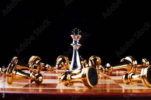 Chess pieces on a board on a black background