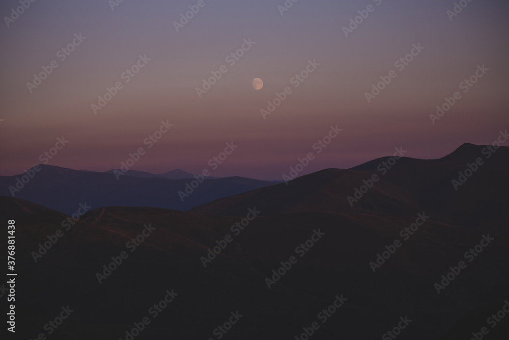 full moon over the mountains