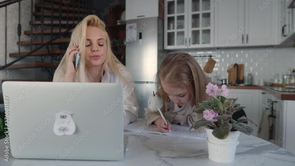 Primary schoolgirl doing homework with mum Primary schoolgirl doing homework with mum