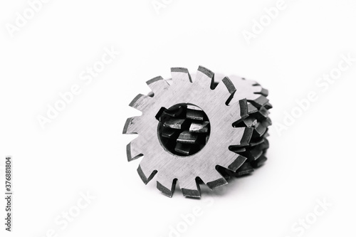 Several metal milling disc cutters for industrial equipment. The tool is isolated on a white background. Close-up