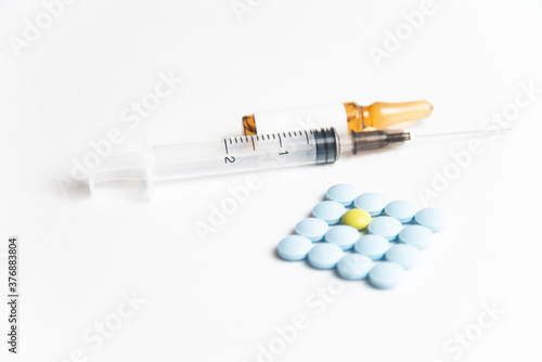 Coronavirus 2019-nCoV outbreak. Pills and syringe on a white isolated background
