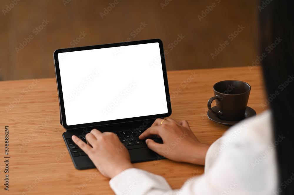 Business woman using digital tablet on wooden table at her office. Business woman using digital tablet on wooden table at her office.