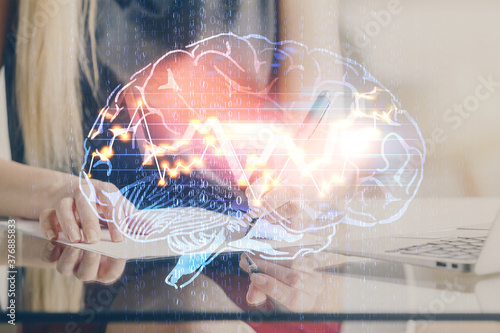 Multi exposure of woman's writing hand on background with brain hud. Concept of learning.