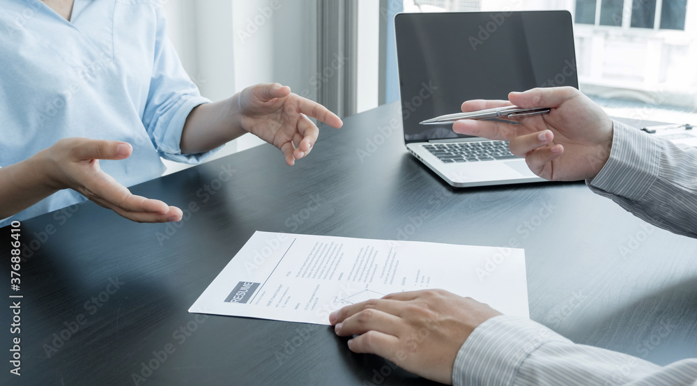 Business people hold a resume and talk to job applicants for job interviews about careers and Her personal history in the company. Recruitment concepts Business people hold a resume and talk to job applicants for job interviews about careers and Her personal history in the company. Recruitment concepts